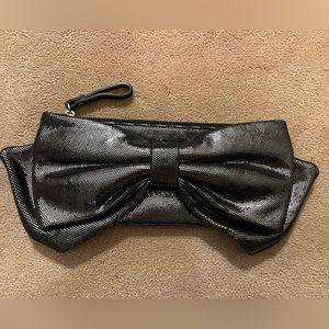 Kate Spade New York bow wristlet black and silver metallic